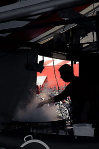 man standing front of wok thumbnail