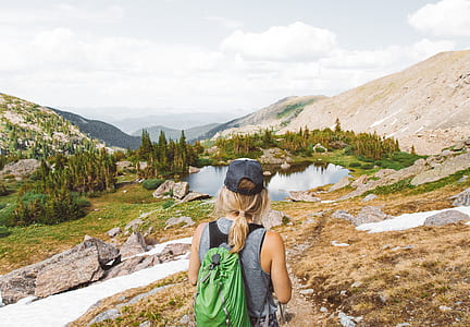 woman standing in the middle of road look at lake thumbnail