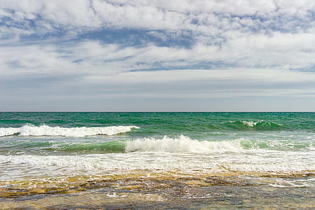 ocean wave under blue and white sky at daytime thumbnail