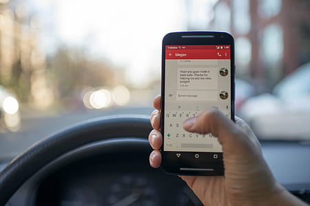 person holding smartphone inside vehicle thumbnail