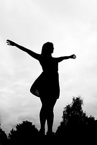 silhouette photo of woman with arms wide open thumbnail