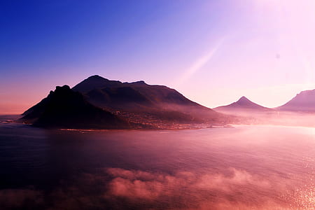 mountain near body of water during daytime thumbnail