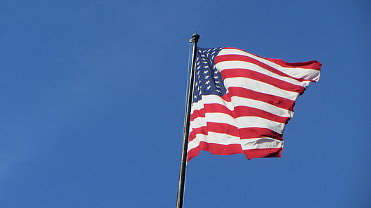 waving flag of America on black post thumbnail