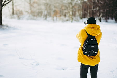 person wearing bubble coat standing on snow thumbnail