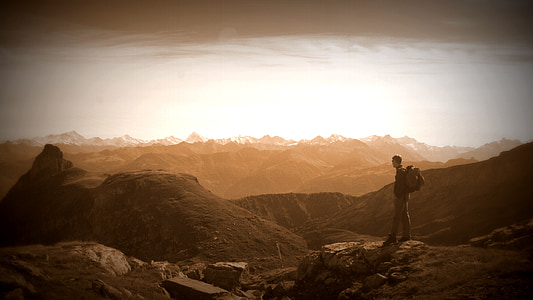 man standing on mountain cliff thumbnail