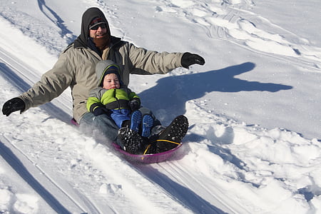 snowboarding man and toddler during daytime thumbnail