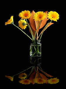 yellow flowers in glass vase thumbnail