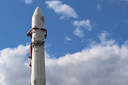 white rocket ship under cloudy sky thumbnail