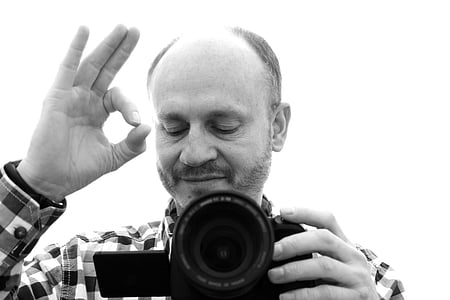 man holding DSLR camera thumbnail