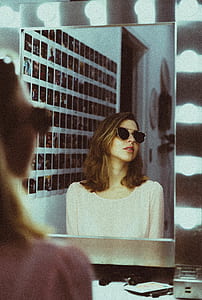 woman wearing sunglasses on front of mirror thumbnail
