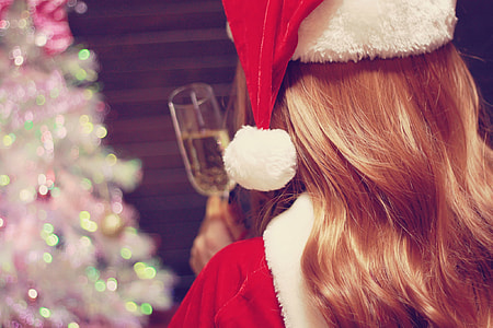 woman wearing red christmas hat and red coat thumbnail