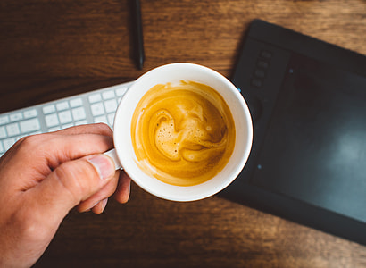 person holding white ceramic mug filled with coffee thumbnail