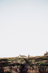 two person standing on green meadow thumbnail