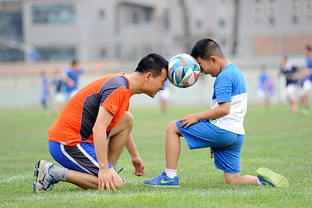 two soccer player with ball between their heads thumbnail