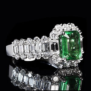 silver-colored clear and green gemstone ring at dark room thumbnail