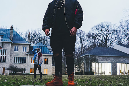 person wearing jacket standing on ground thumbnail