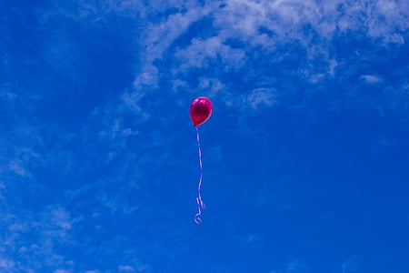red balloon floating in sky thumbnail