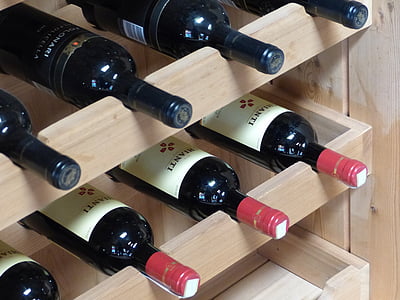 assorted labeled wine bottles on rack thumbnail