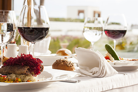 food on plate with wine glasses on table closeup photo thumbnail
