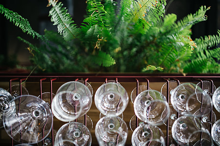 A big bunch of wine glasses hanging from a holder thumbnail