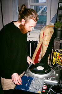 Man in Green Sweater Using Dj Controller thumbnail
