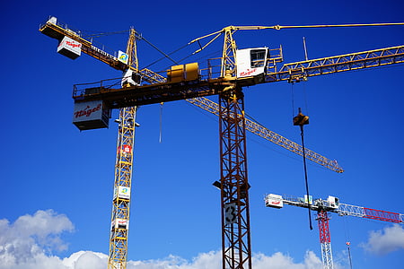 yellow and black tower cranes thumbnail