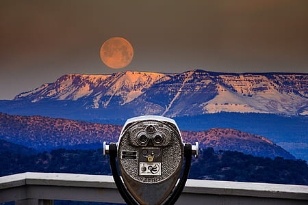 black and gray telescope in front of mountain and moon thumbnail