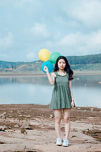 Woman Holding Three Balloons thumbnail
