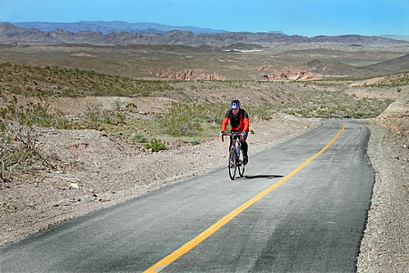 man riding a bicycle on road thumbnail