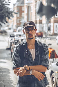 man wearing brown curve-brimmed cap thumbnail