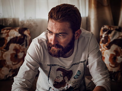 man wearing white shirt sitting on sofa looking sideways thumbnail