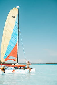woman in black bikini sitting on sailboat thumbnail