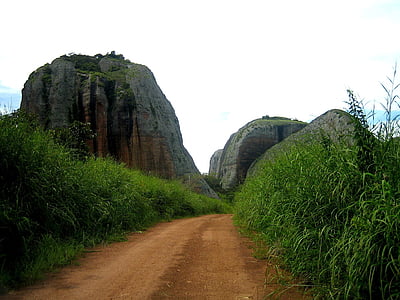 empty road near the rock formation photography thumbnail