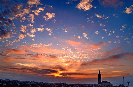 buildings under white and orange sky thumbnail