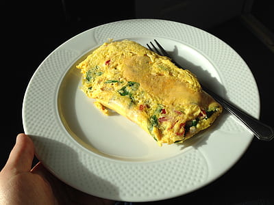 omelette on round white ceramic plate thumbnail
