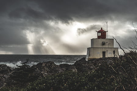 house near body of water during crepuscular rays thumbnail