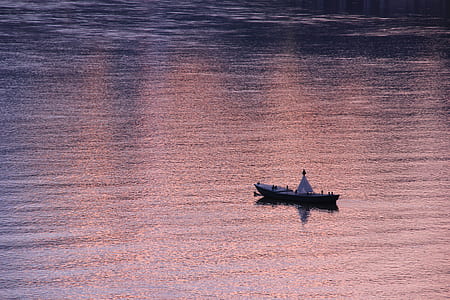 brown and white boat in body of water thumbnail
