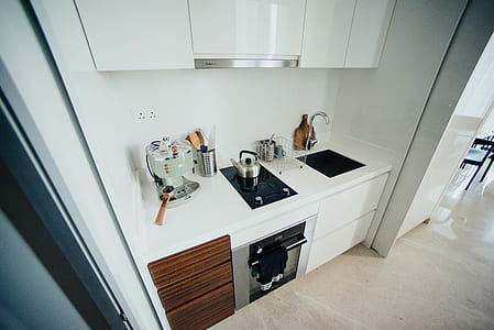 silver kettle on black induction range oven thumbnail