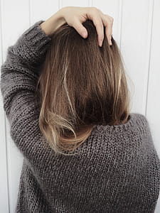 Woman Wearing Black Crew-neck Knitted Long-sleeved Shirt Beside White Wall thumbnail