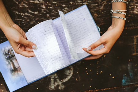 Woman reading a diary by the table thumbnail