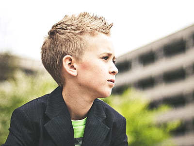 boy in black suit jacket and green crew-neck top thumbnail