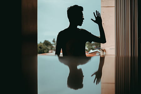 young man, reflection, silhouette, man in glass, man waving thumbnail