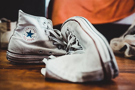 pair of white Converse All-Star high-top sneakers on the floor thumbnail