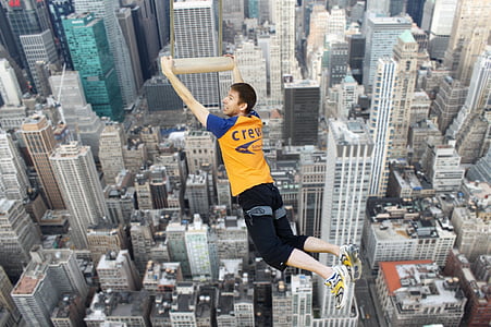 aerial photo of man holding on brown panel thumbnail