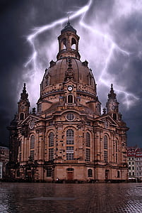 Beige Concrete Building Under Gray Clouds and Lighting thumbnail