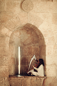 woman in white robe playing harp thumbnail