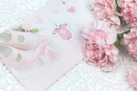flat lay photography of pink card beside pink flowers thumbnail