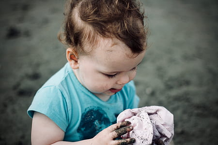 toddler's holding cloth with dirt thumbnail
