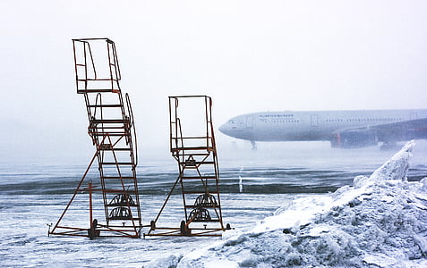 two black metal plane stairs near airplane thumbnail