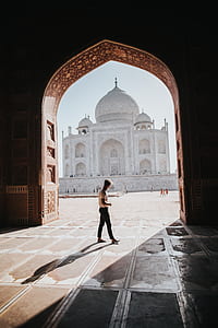 man walking while looking at taj mahal thumbnail